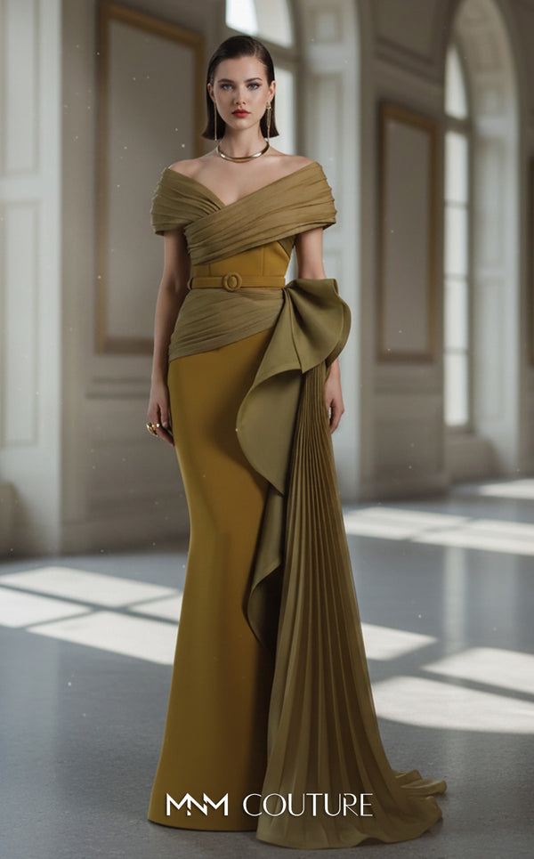 A sophisticated MNM Couture 2692 off-shoulder mermaid gown featuring pleated foldover details, ruffled side peplums, and a sweeping train. | Couture Shop LA