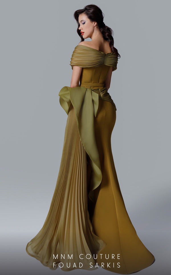 A sophisticated MNM Couture 2692 off-shoulder mermaid gown featuring pleated foldover details, ruffled side peplums, and a sweeping train. | Couture Shop LA