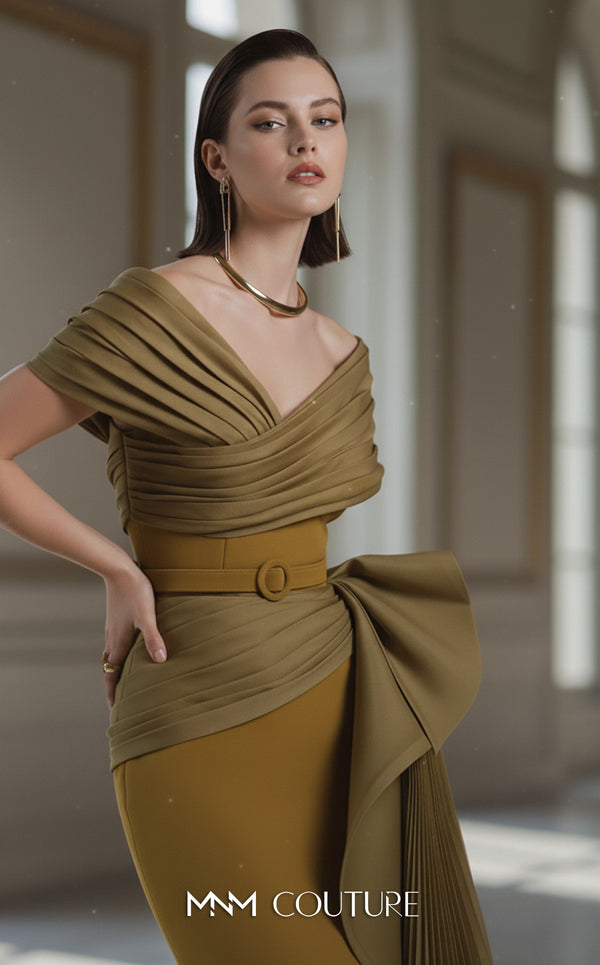 A sophisticated MNM Couture 2692 off-shoulder mermaid gown featuring pleated foldover details, ruffled side peplums, and a sweeping train. | Couture Shop LA