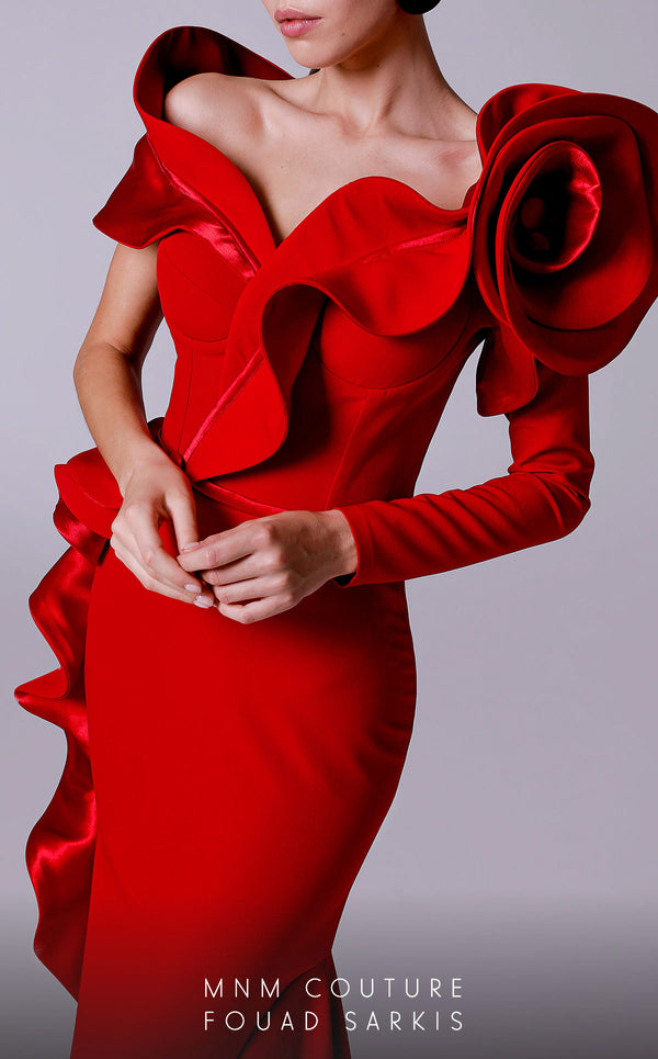 An elegant MNM Couture 2714 satin-crepe mermaid gown featuring long sleeves, ruffled details, a V-neckline, and a rosette accent for added flair. | Couture Shop LA