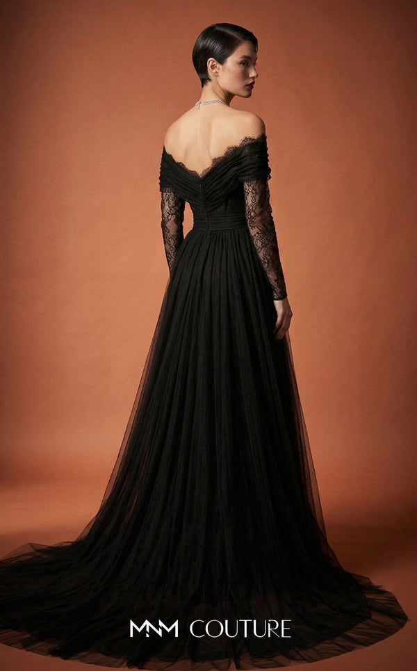 MNM Couture Style B1141 featuring a flared black organza gown with an off-the-shoulder sweetheart neckline, long sleeves, and a long, flowing train cape at the back.| Couture Shop LA.