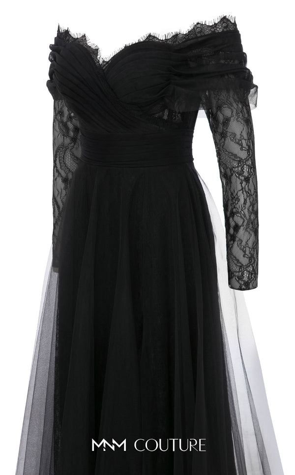 MNM Couture Style B1141 featuring a flared black organza gown with an off-the-shoulder sweetheart neckline, long sleeves, and a long, flowing train cape at the back.| Couture Shop LA.