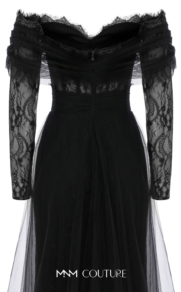MNM Couture Style B1141 featuring a flared black organza gown with an off-the-shoulder sweetheart neckline, long sleeves, and a long, flowing train cape at the back.| Couture Shop LA.