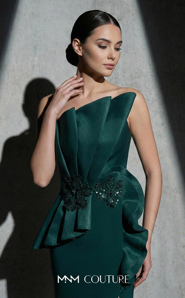 MNM Couture Style B1188 strapless column gown with an asymmetrical pleated neckline, side slit, and beaded floral peplum. | Couture Shop LA
