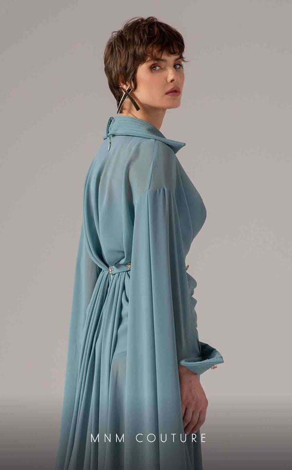 MNM Couture Style E0093 in mint green, featuring a flared silhouette, a collared V-neckline with brooch details, a belted waist, and long cape sleeves that form a train. | Couture Shop LA