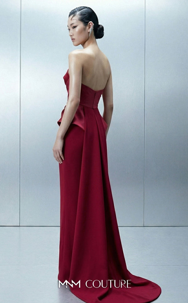 MNM Couture E0146 strapless draped satin mermaid gown with arched neckline, darted bust, illusion peplum, crisscross waist, and dramatic back train | Couture Shop LA.