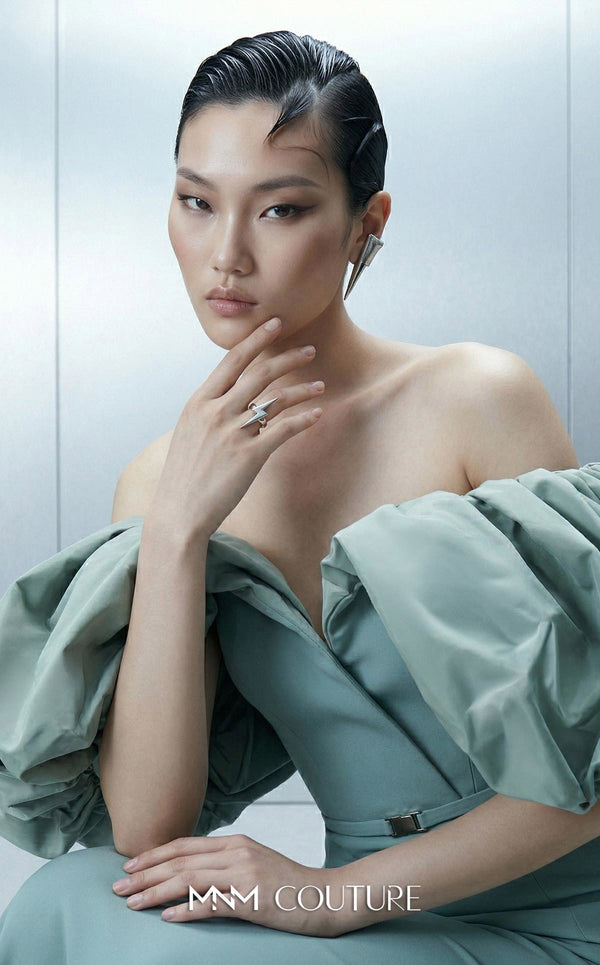 Long straight fitted crepe dress featuring an asymmetrical bodice and puffy taffeta sleeves for MNM Couture Style E0165 | Couture Shop LA.