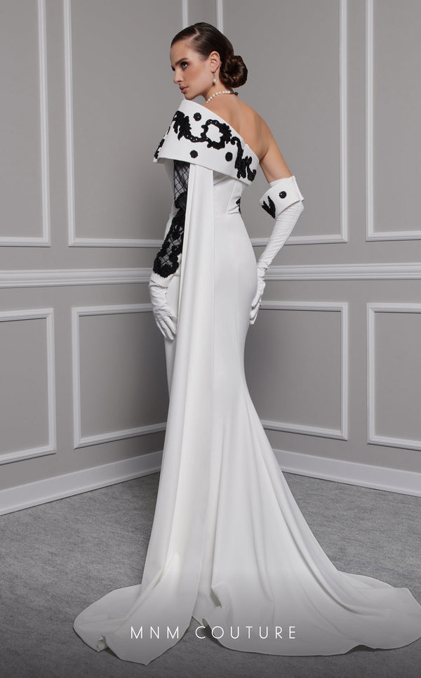 Elegant MNM Couture F02803 evening gown featuring a strapless, off-shoulder design with a single long sleeve, adorned with intricate beading and tassels | Couture Shop LA