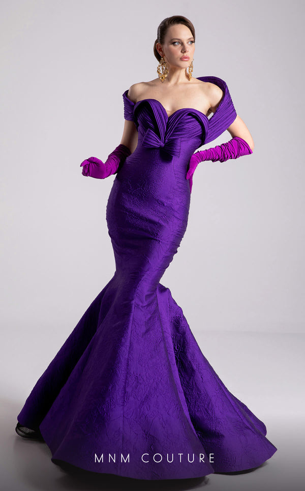 MNM Couture Style F02901 dress showcasing a pleated sweetheart neckline, mid-bow detail, and a stunning mermaid silhouette. / Couture Shop LA