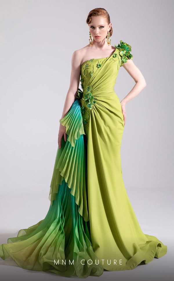 MNM Couture Style F02911 one-shoulder green gown with a draped bodice, floral appliqués at shoulder and hip, and a large pleated ombre ruffle train. | Couture Shop LA