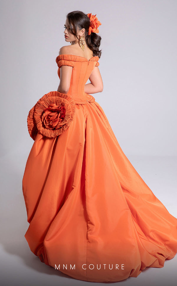 MNM Couture Style F02913 featuring an orange taffeta dress with off-shoulder cap sleeves, drapery on the neckline and waist, a high-low skirt with a cascading train, and a floral accent. | MNM Couture.
