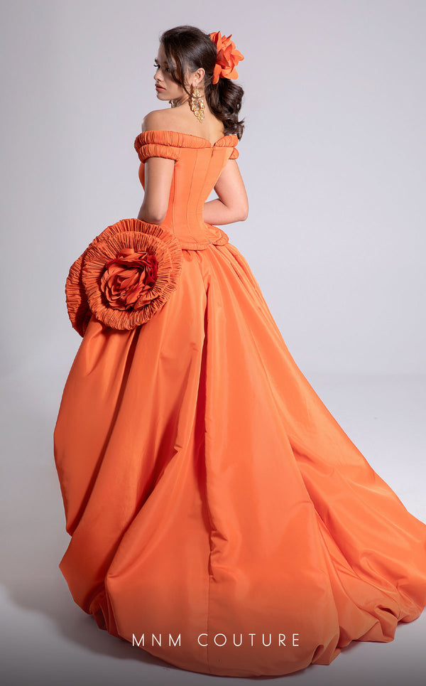 MNM Couture Style F02913 featuring an orange taffeta dress with off-shoulder cap sleeves, drapery on the neckline and waist, a high-low skirt with a cascading train, and a floral accent. | MNM Couture.