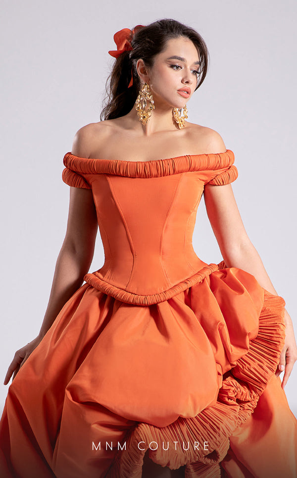 MNM Couture Style F02913 featuring an orange taffeta dress with off-shoulder cap sleeves, drapery on the neckline and waist, a high-low skirt with a cascading train, and a floral accent. | MNM Couture.