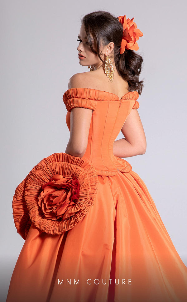 MNM Couture Style F02913 featuring an orange taffeta dress with off-shoulder cap sleeves, drapery on the neckline and waist, a high-low skirt with a cascading train, and a floral accent. | MNM Couture.