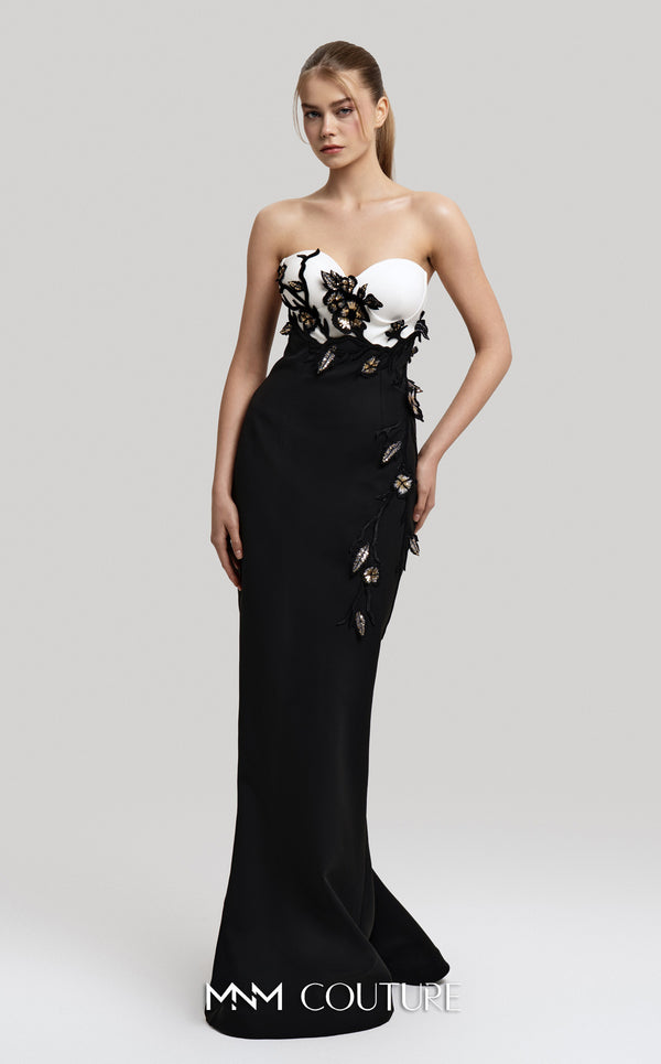 MNM Couture Style F02917 showing a fitted green column gown with a pink strapless bustier top, adorned with embroidered floral appliqués, and paired with a matching green cape. | Couture Shop LA