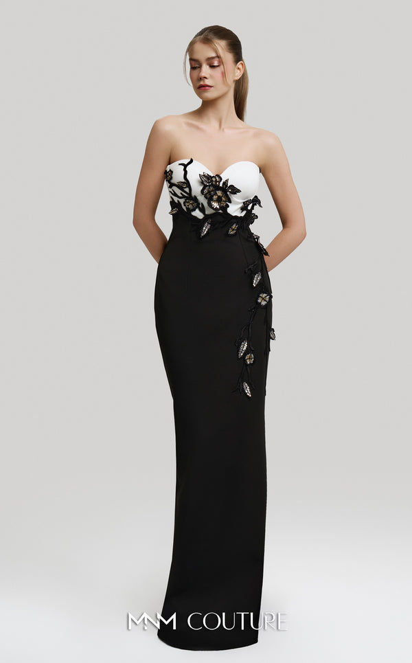 MNM Couture Style F02917 showing a fitted green column gown with a pink strapless bustier top, adorned with embroidered floral appliqués, and paired with a matching green cape. | Couture Shop LA