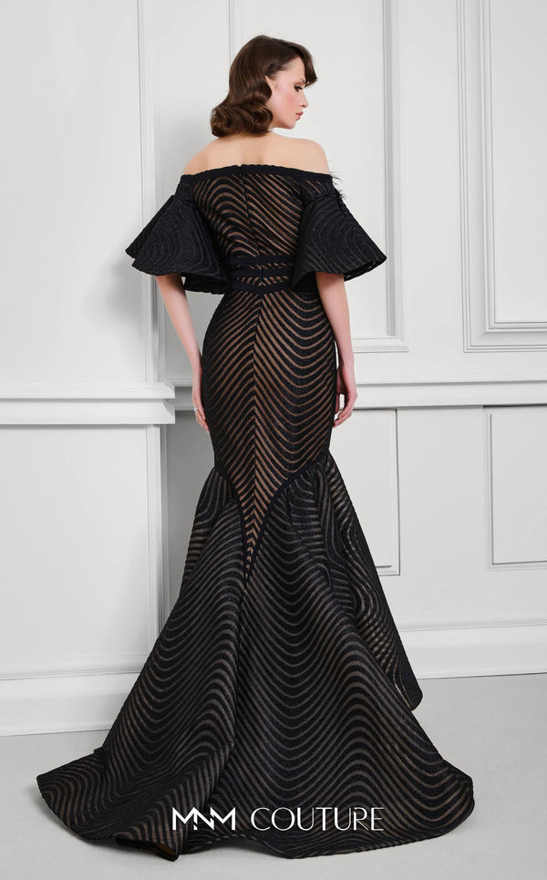 MNM Couture Style F02925 - Elegant black mesh mermaid gown featuring off-shoulder ruffled bell sleeves, a deep V-neckline, and a plumage brooch. | Couture Shop LA