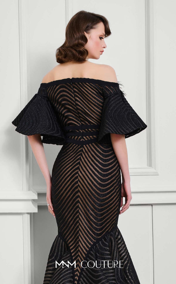 MNM Couture Style F02925 - Elegant black mesh mermaid gown featuring off-shoulder ruffled bell sleeves, a deep V-neckline, and a plumage brooch. | Couture Shop LA