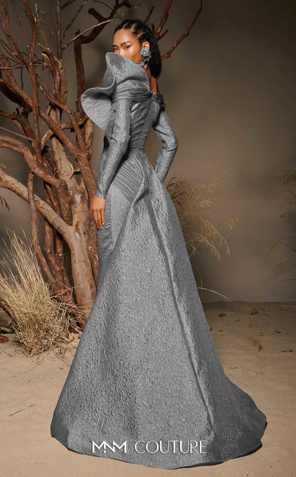MNM Couture F02982 textured jacquard gown with off-the-shoulder long sleeves, pleated fans on the left shoulder, and a dramatic back train.|Couture Shop LA