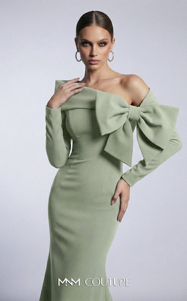 MNM Couture F03007 mint crepe long-sleeve mermaid gown with asymmetric large folded boat neckline, bare left shoulder, and oversized flat sculptural bow at the bust | Couture Shop LA