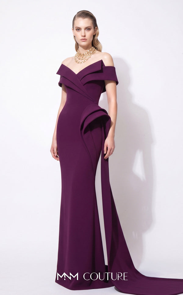 MNM Couture F03064 deep magenta crepe column gown with off-shoulder deep V cap bands, low open back, and oversized sculptural fin peplum at the left hip cascading into a side train | Couture Shop LA