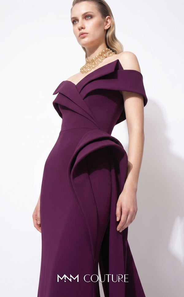 MNM Couture F03064 deep magenta crepe column gown with off-shoulder deep V cap bands, low open back, and oversized sculptural fin peplum at the left hip cascading into a side train | Couture Shop LA