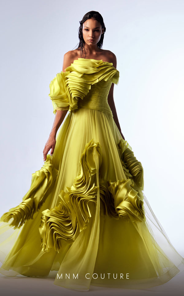 Green organza A-line evening gown with satin ruffles, structured corset bodice, and one off-the-shoulder sleeve highlighting MNM Couture Style G1736 | Couture Shop LA.
