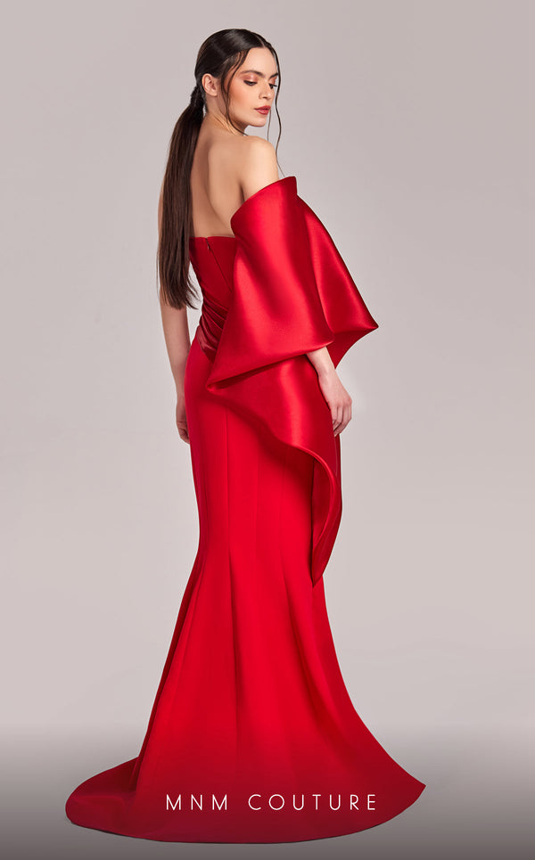 MNM Couture G1803 gown featuring a sleek mermaid silhouette, organza draping, and an exaggerated one-shoulder sleeve. | Couture Shop LA