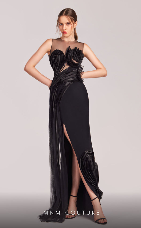 MNM Couture G1816 black crepe column gown with high sheer illusion neckline, two 3D sculptural rose blooms at the bust, cascading organza petal trail, rose bloom on the open back, and high right-leg slit | Couture Shop LA.