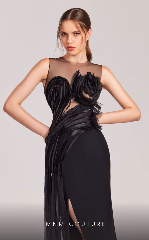 MNM Couture G1816 black crepe column gown with high sheer illusion neckline, two 3D sculptural rose blooms at the bust, cascading organza petal trail, rose bloom on the open back, and high right-leg slit | Couture Shop LA.