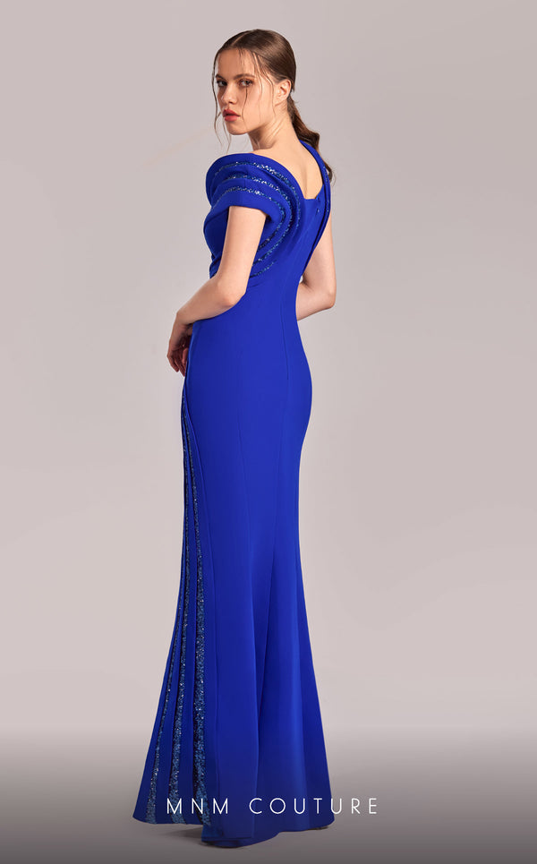 MNM Couture Style G1833 royal blue rayon crepe column gown featuring a pleated bust, asymmetric V-neckline, off-shoulder strap sleeve, and elegant slit above the knee
