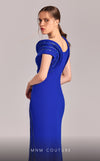 MNM Couture Style G1833 royal blue rayon crepe column gown featuring a pleated bust, asymmetric V-neckline, off-shoulder strap sleeve, and elegant slit above the knee