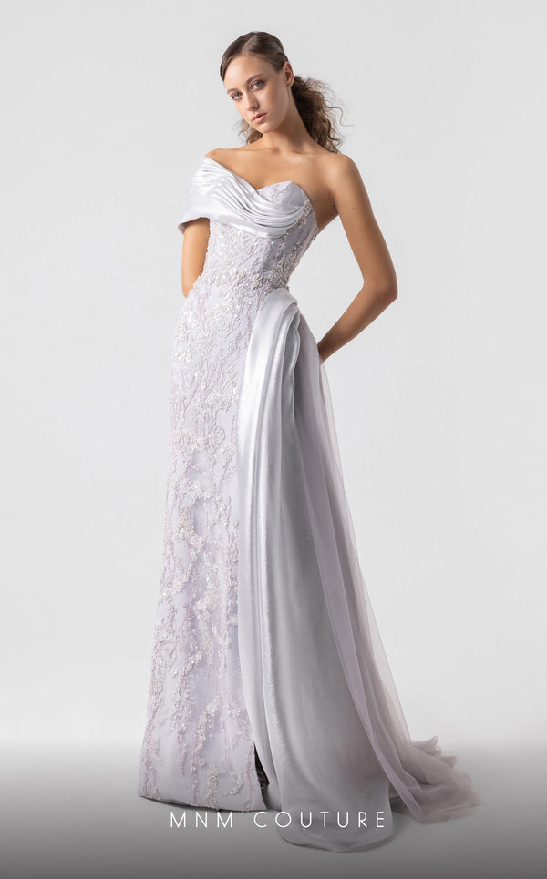 MNM Couture G1932 silver draped gown with off-shoulder design and high slit for evening elegance. | Couture Shop LA