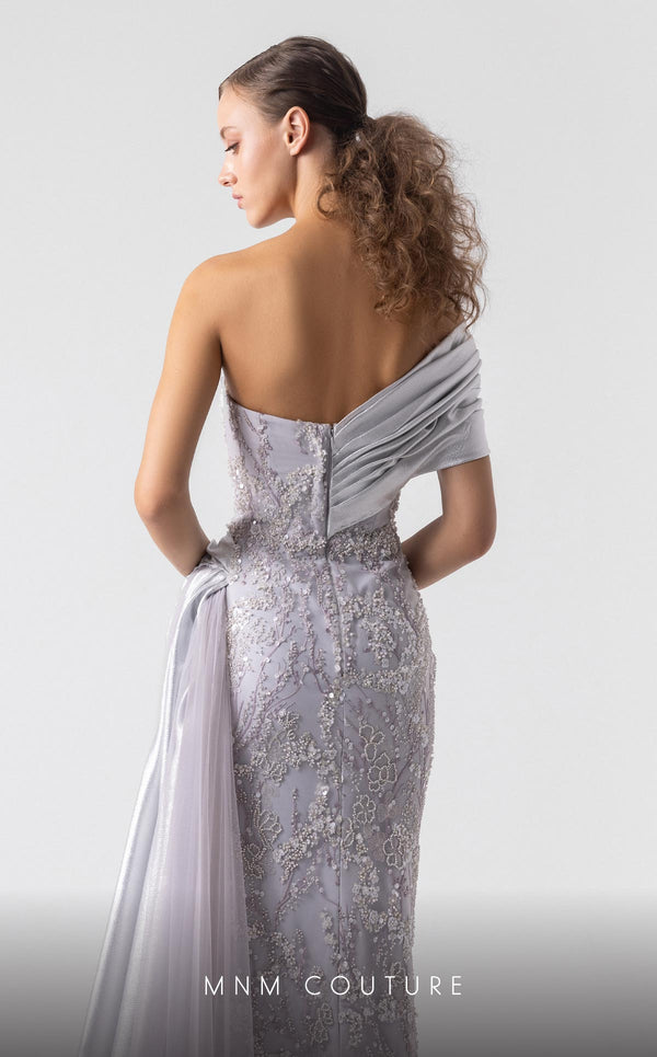 MNM Couture G1932 silver draped gown with off-shoulder design and high slit for evening elegance. | Couture Shop LA
