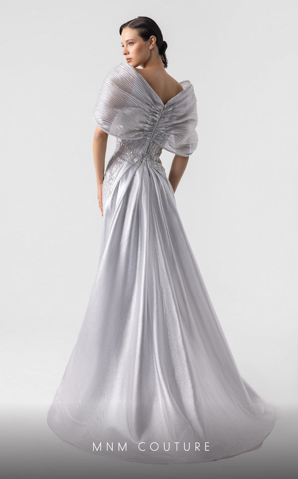 MNM Couture G1939 silver lace gown with off-shoulder details and shimmering embellishments. | Couture Shop LA
