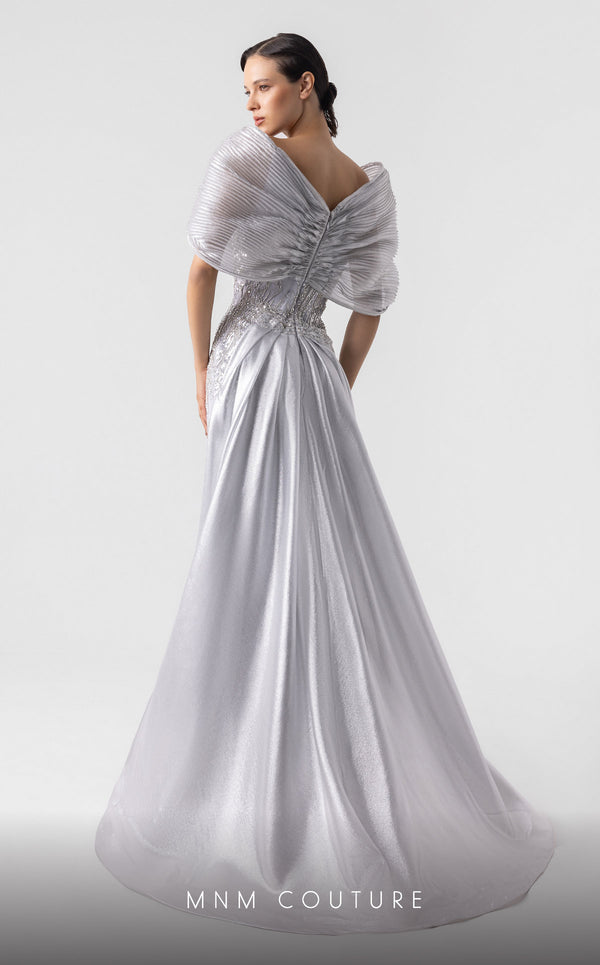 MNM Couture G1939 silver lace gown with off-shoulder details and shimmering embellishments. | Couture Shop LA