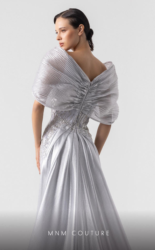 MNM Couture G1939 silver lace gown with off-shoulder details and shimmering embellishments. | Couture Shop LA