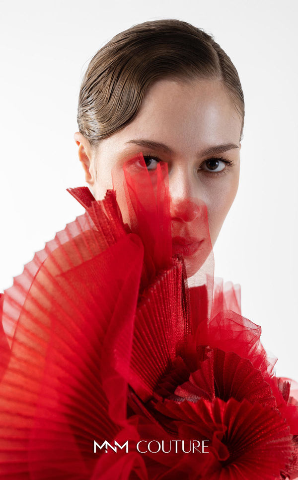 MNM Couture Style G2001 showcasing a red crepe evening gown with dramatic draped tulle bust, pleated organza detailing, and graceful trailing tulle train | Couture Shop LA