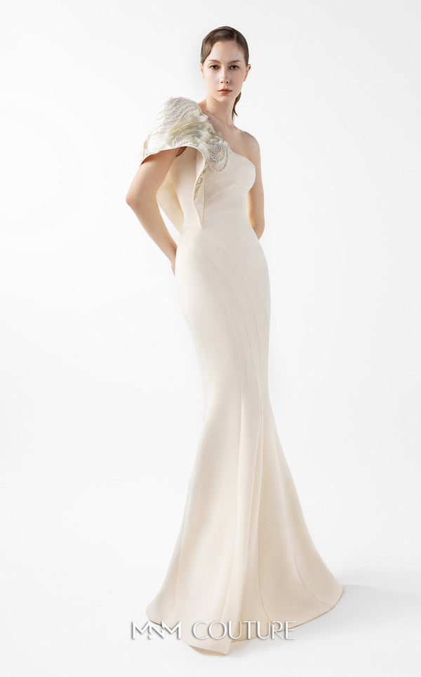 MNM Couture Style G2003 showcasing a cream one-shoulder mermaid gown with sculptural organza manipulation and cascading pearl embroidery on the shoulder. | Couture Shop LA