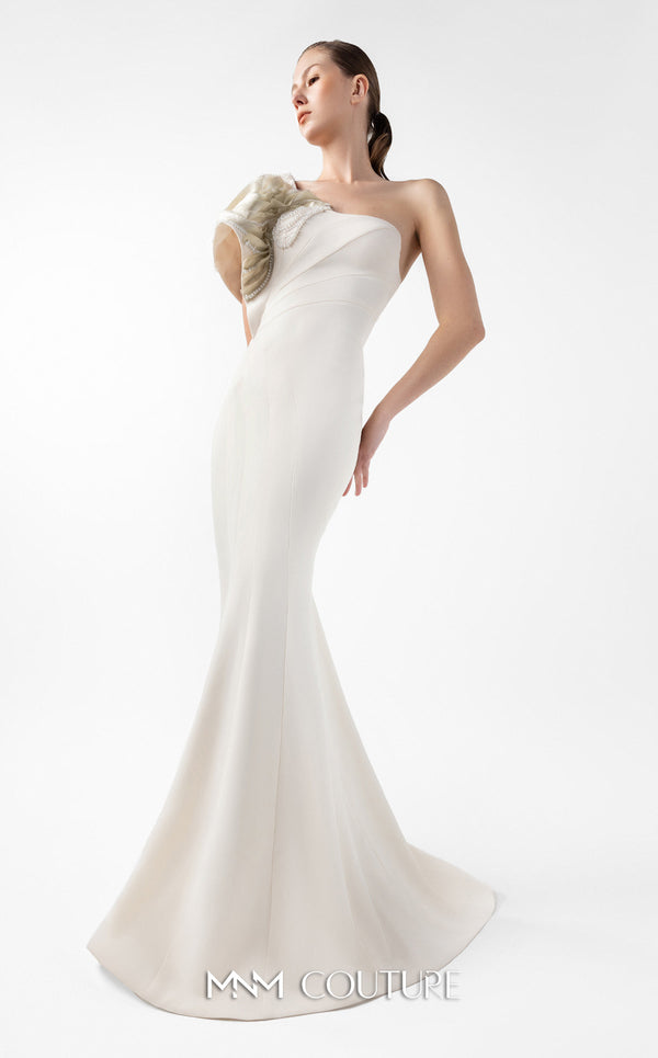 MNM Couture Style G2003 showcasing a cream one-shoulder mermaid gown with sculptural organza manipulation and cascading pearl embroidery on the shoulder. | Couture Shop LA