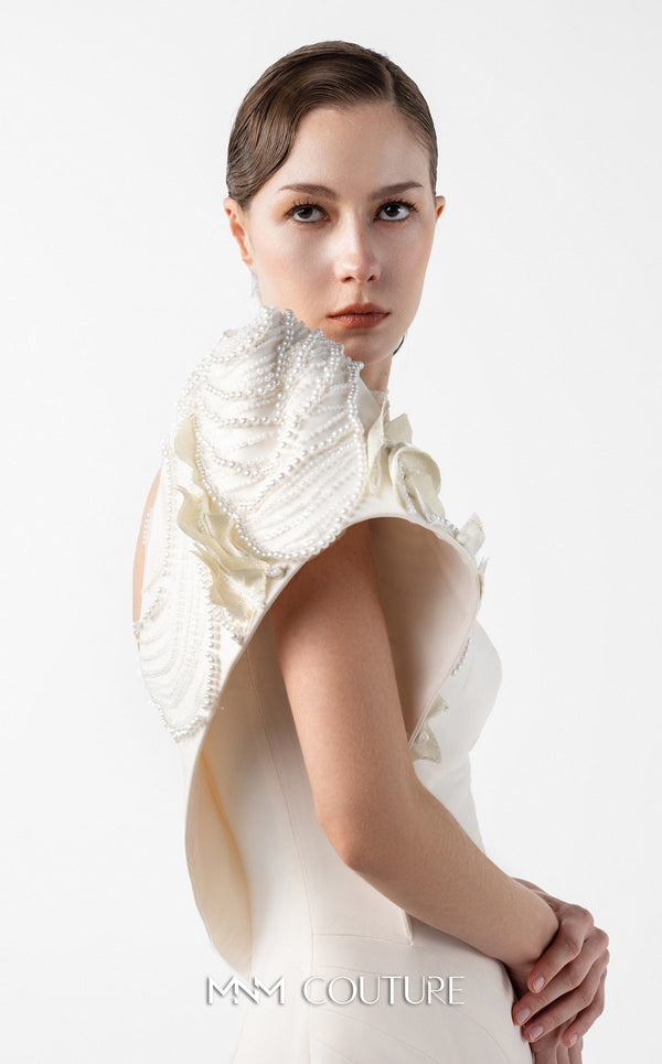 MNM Couture Style G2003 showcasing a cream one-shoulder mermaid gown with sculptural organza manipulation and cascading pearl embroidery on the shoulder. | Couture Shop LA