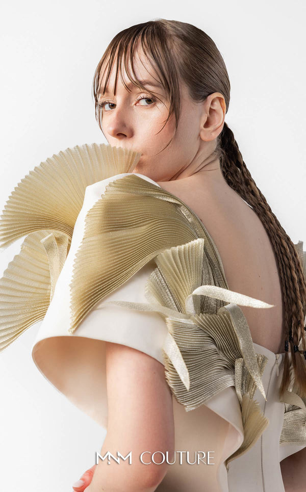 MNM Couture Style G2005 showcasing a cream mermaid gown with architectural golden pleated organza shoulder detailing resembling sculptural wings and ethereal fan accents | Couture Shop LA