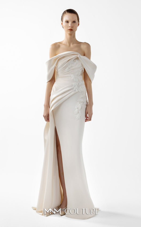MNM Couture Style G2007 showcasing a cream crepe gown with dramatic off-shoulder satin sleeves, exquisite handmade embroidery on the bodice, and subtle thigh-high slit | Couture Shop LA