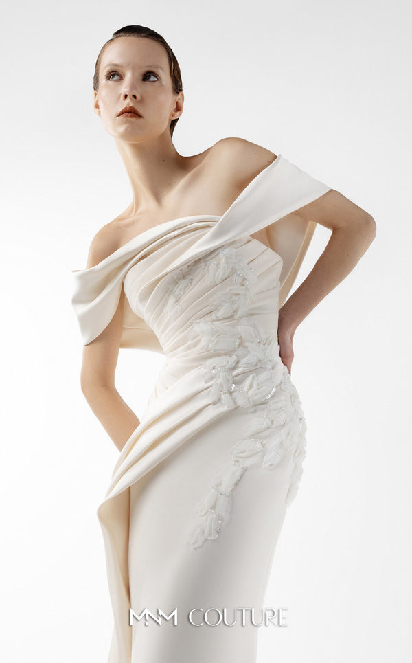 MNM Couture Style G2007 showcasing a cream crepe gown with dramatic off-shoulder satin sleeves, exquisite handmade embroidery on the bodice, and subtle thigh-high slit | Couture Shop LA