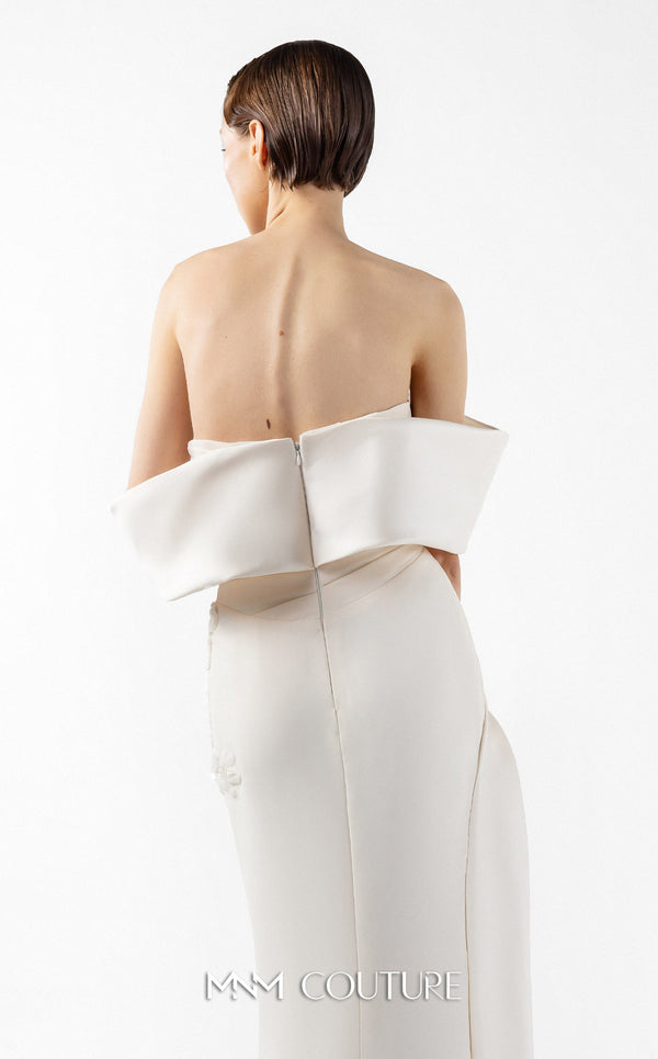 MNM Couture Style G2007 showcasing a cream crepe gown with dramatic off-shoulder satin sleeves, exquisite handmade embroidery on the bodice, and subtle thigh-high slit | Couture Shop LA