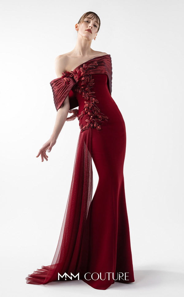 MNM Couture Style G2022 showcasing a burgundy mermaid gown with pleated lamé organza shoulders, intricate embroidery, and a tulle train | Couture Shop LA