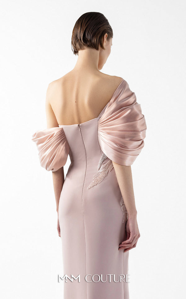 MNM Couture Style G2034 showcasing a salmon blush crepe gown with metallic off-shoulder neckline, delicate lace and tulle side embellishments, and a dramatic high slit | Couture Shop LA
