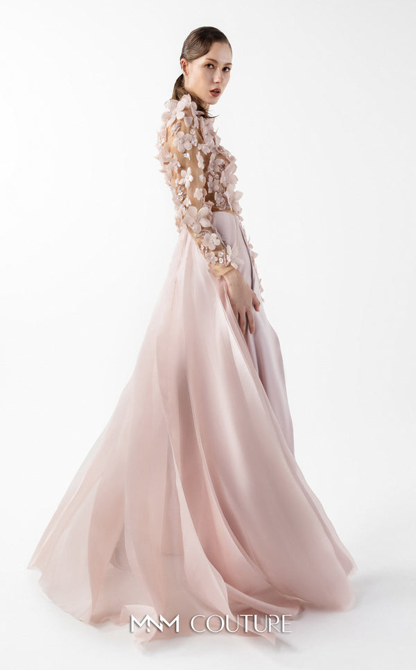 MNM Couture Style G2035 showcasing a blush pink gown with sheer illusion bodice, long sleeves adorned with 3D floral appliques, lace inserts, and flowing envelope skirt | Couture Shop LA