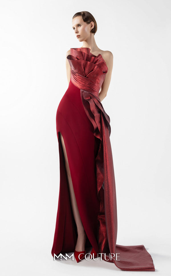 MNM Couture Style G2037 showcasing a strapless burgundy crepe gown with a sculpted, layered lamé organza bodice, a flowing train, and a high slit. | Couture Shop LA