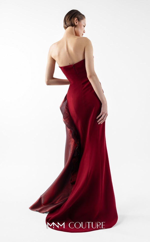 MNM Couture Style G2037 showcasing a strapless burgundy crepe gown with a sculpted, layered lamé organza bodice, a flowing train, and a high slit. | Couture Shop LA